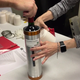 A canister is loaded with a wine bottle for a trip to the International Space Station.